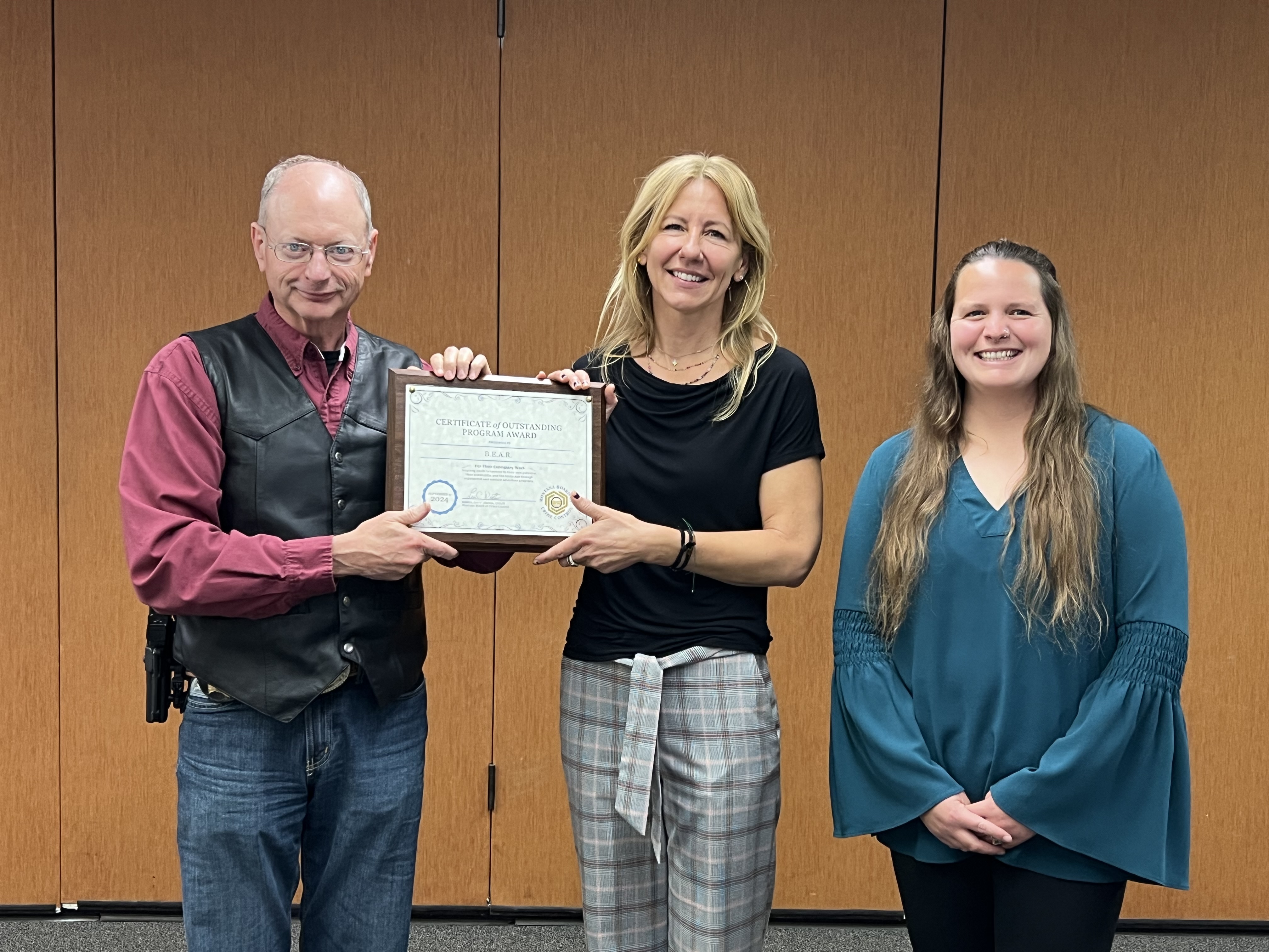 MBCC Chairman Leo Dutton presents Diane Olsen and Mallory James from B.E.A.R. with the Certificate of Outstanding Program Award at the September 2024 Board Meeting in Lewistown, MT.